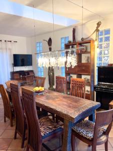 a dining room with a large wooden table and chairs at La Galería in Calera