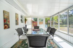 a dining room with a glass table and chairs at La Niña Nokomis Beach & Venice Island Fenced In Yard in Nokomis