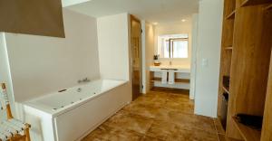 a bathroom with a bath tub and a sink at ICON Valparaiso - Adults Only in Cala Murada +91 photos