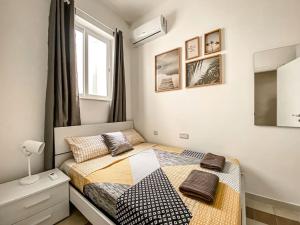 a bedroom with a bed with two pillows on it at Unique two bedrooms apartment 6 in Il-Gżira