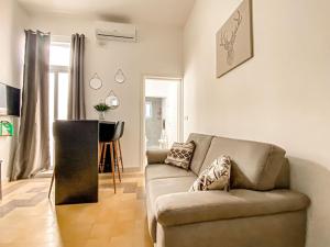 a living room with a couch and a table at Unique two bedrooms apartment 6 in Il-Gżira