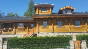a large wooden house with a balcony on top at Le Renne Blanc Pyrénées de France in Font-Romeu