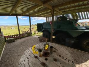 a military truck parked in a building with a table at Stunning views & sunrises from Sally Saracen in St Ives
