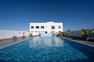 a swimming pool in front of a white building at Paris-Oasis Casablanca avec piscine panoramique in Casablanca