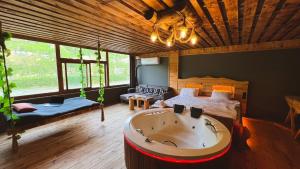 a large room with a tub in the middle of a bedroom at Heaven Wooden Vip Bungalow in Rize