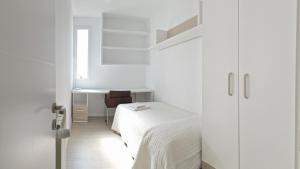 a white bedroom with a bed and a desk at SPACE CENTER MADRID in Madrid