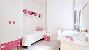 a small white room with a bed and a desk at SPACE CENTER MADRID in Madrid