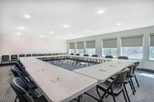 a large room with rows of tables and chairs at Ramada by Wyndham Hendersonville in Hendersonville