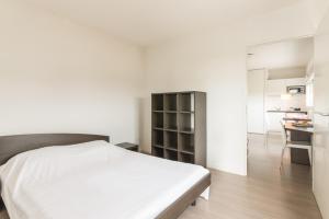 a bedroom with a white bed and a desk at City Résidence Nantes La Chantrerie in Nantes