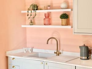 a kitchen with a sink and white cabinets at The Bradley in Market Weighton