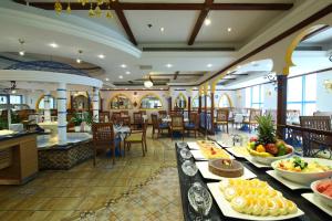 a restaurant with tables with plates of food on them at Coral Dubai Deira Hotel in Dubai