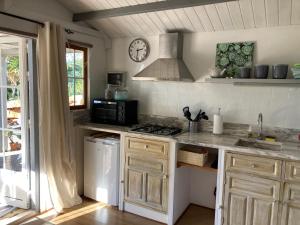 a kitchen with a sink and a stove top oven at Quinta Bohemia in Moncarapacho