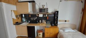 a small kitchen with a desk and a microwave at Стаи за гости При Зори и Ицо in Nova Zagora