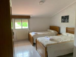 Ένα ή περισσότερα κρεβάτια σε δωμάτιο στο Hostal Sequeiros