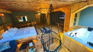 a room with a bed and a bath tub at Heaven Wooden Vip Bungalow in Rize