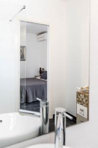 サン・リョレンツ・デ・バラフィアにあるCan Guaschのバスルーム(鏡、洗面台、ベッド付)