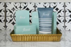 a tray with three boxes and a bottle of hair products at Hotel Figueroa, Unbound Collection by Hyatt in Los Angeles