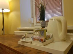 a kitchen counter with a sink and a hair dryer at Nėris Inn Terraces in Vilnius +47 photos