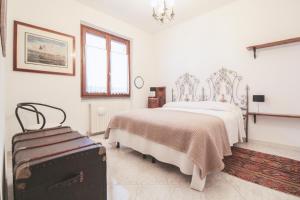 מיטה או מיטות בחדר ב-Villa del Grillo Parlante