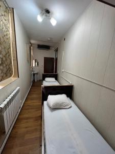 a row of beds in a room at Iso Hostel in Tashkent