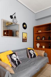 a living room with a bed with pillows on it at Adorable Apartment in the center in Volos