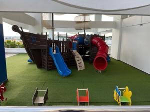 a play room with a playground with a slide at SNHomestay1826 Sea View @ The Wave Residence in Melaka