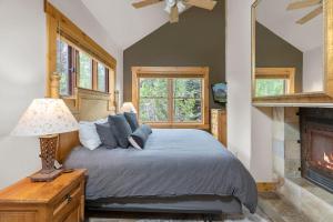 a bedroom with a bed and a fireplace at 2 BR Condominium - Luxury Skiin out - on River to0 in Telluride