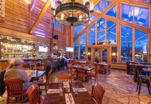 a restaurant with people sitting at tables and a bar at 2 BR Condominium - Luxury Skiin out - on River to0 in Telluride
