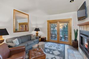 a living room with a couch and a tv at Have It All Ski in out Affordable Too in Telluride