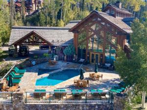 a large house with a pool in front of it at Have It All Ski in out Affordable Too in Telluride