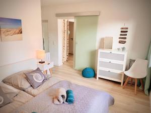 - une chambre avec un chien dormant sur un lit dans l'établissement FeWo STRANDGUT- Familien - Hunde - strandnah - eigene Terrasse - Sauna & Wellness, à Sierksdorf