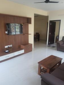 a living room with a couch and a table at Castle Dollars in Bengaluru