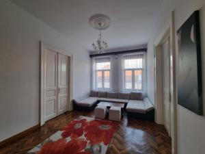 a living room with a couch and a window at Downtown Fuchsl Palace in Oradea