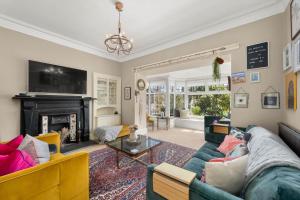 a living room with a couch and a fireplace at Luxury 5 bedroom Victorian home with Hot Tub in Blairgowrie