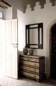 a mirror on top of a dresser in a room at Riad MALAÏKA in Essaouira