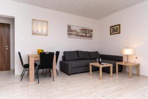 a living room with a couch and a table at Joseph - superior sea bay and mountain view in Cavtat