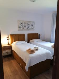 a bedroom with two beds with towels on them at Apartment Grbin in Pula