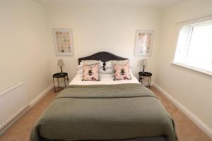 um quarto com uma cama grande e 2 almofadas em The Cottage IH3ATL em Stockton-on-Tees