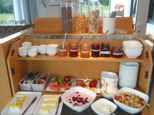 a cabinet filled with lots of food and other foods at Gästehaus Brütting 