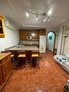 a kitchen with a table and chairs in a room at El Cardenal in Playa del Cura