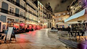an empty street with tables and chairs and buildings at Discovery | Porto-Flores in Porto
