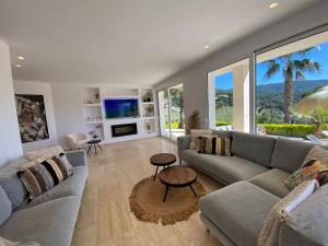 a living room with a couch and a tv at Villa De Oro in Calonge