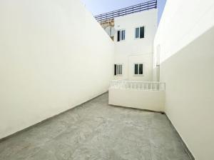 an empty hallway of a building with white walls at 1 Bedroom Penthouse in Gzira in Il-Gżira