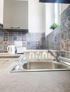 a kitchen counter with a sink in a kitchen at 1 Bedroom Penthouse in Gzira in Il-Gżira