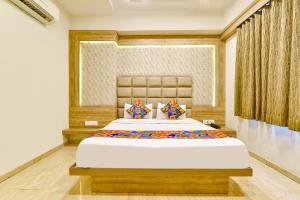 a bedroom with a large bed in a room at FabHotel Hill Park in Ahmedabad