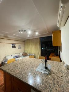 a kitchen with a counter top and a living room at El Cardenal in Playa del Cura