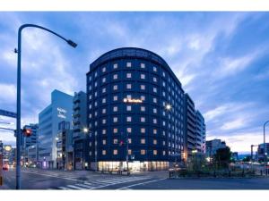 a tall blue building on a city street at night at The OneFive Kyoto Shijo - Vacation STAY 41807v in Kyoto