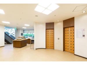 a row of lockers in a room with a table at The OneFive Okayama - Vacation STAY 41839v in Okayama