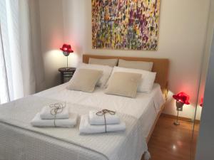 a bedroom with a bed with two towels on it at LOFT 360° Nice in Nice