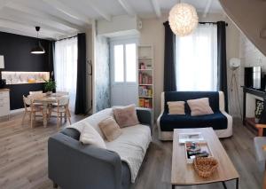 een woonkamer met een bank en een tafel bij Charmante maison de Ville , 4 personnes , LES HERBIERS in Les Herbiers